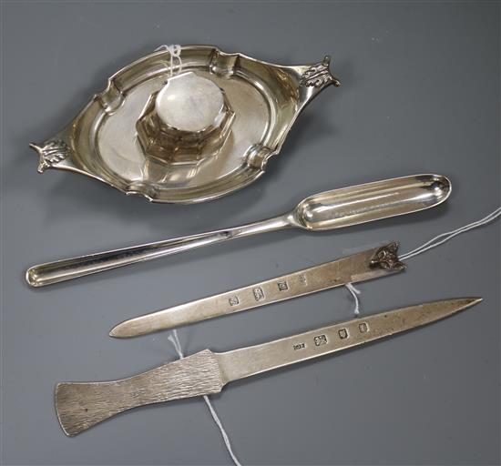 A George III silver marrow scoop, two silver letter openers and a silver ink stand